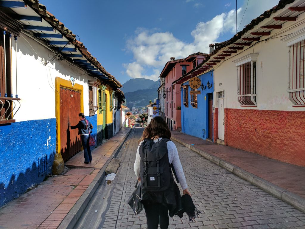 Traveler walking down a colorful street in Bogota